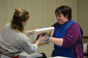 Kathryn working with Chloe on a swirl technique with an art project