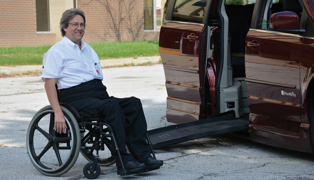 Scott in parking lot next to the ramp on his van