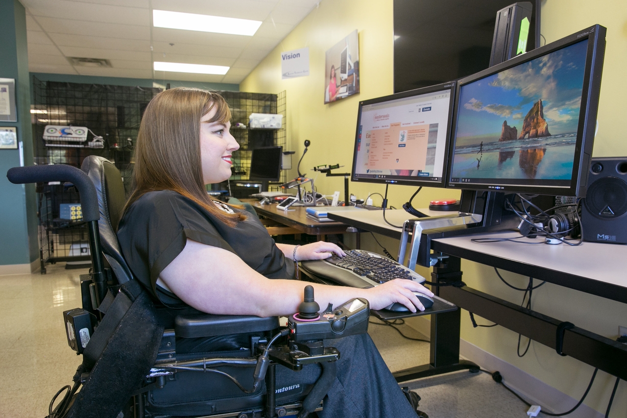 Woman in wheelchair working on computer.