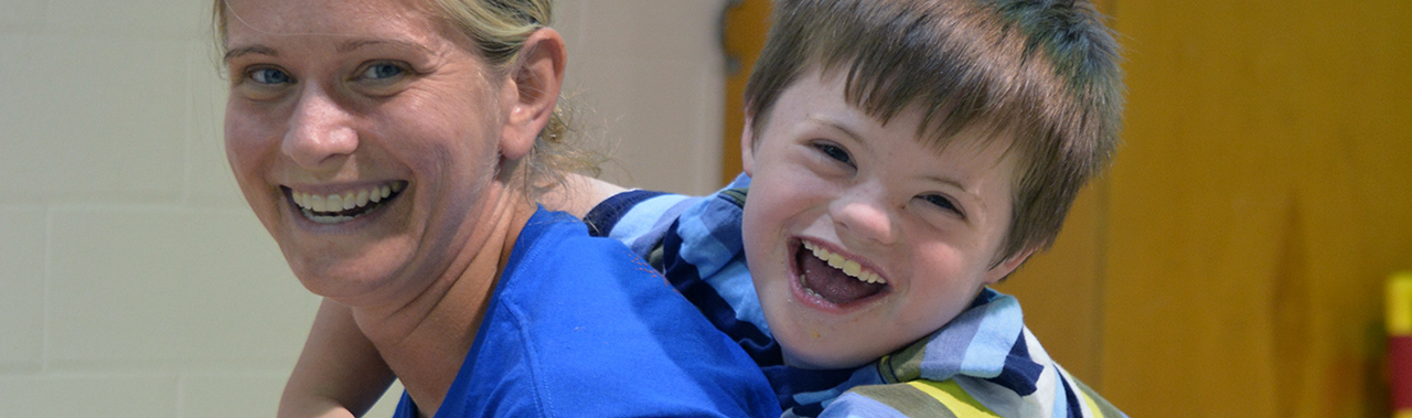 An ESC employee enjoying time with a child