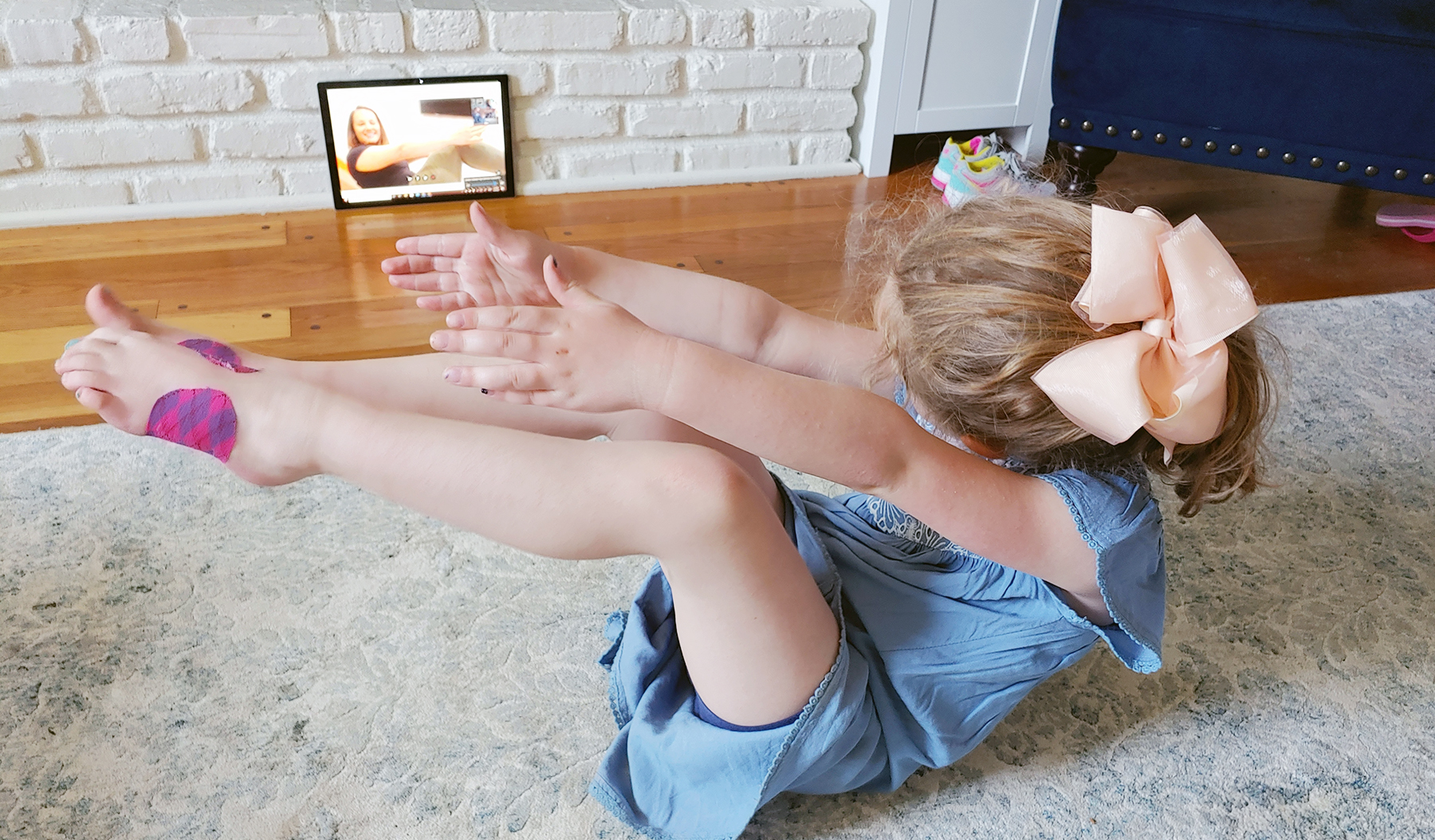 young girl participating in a telehealth physical therapy appointment
