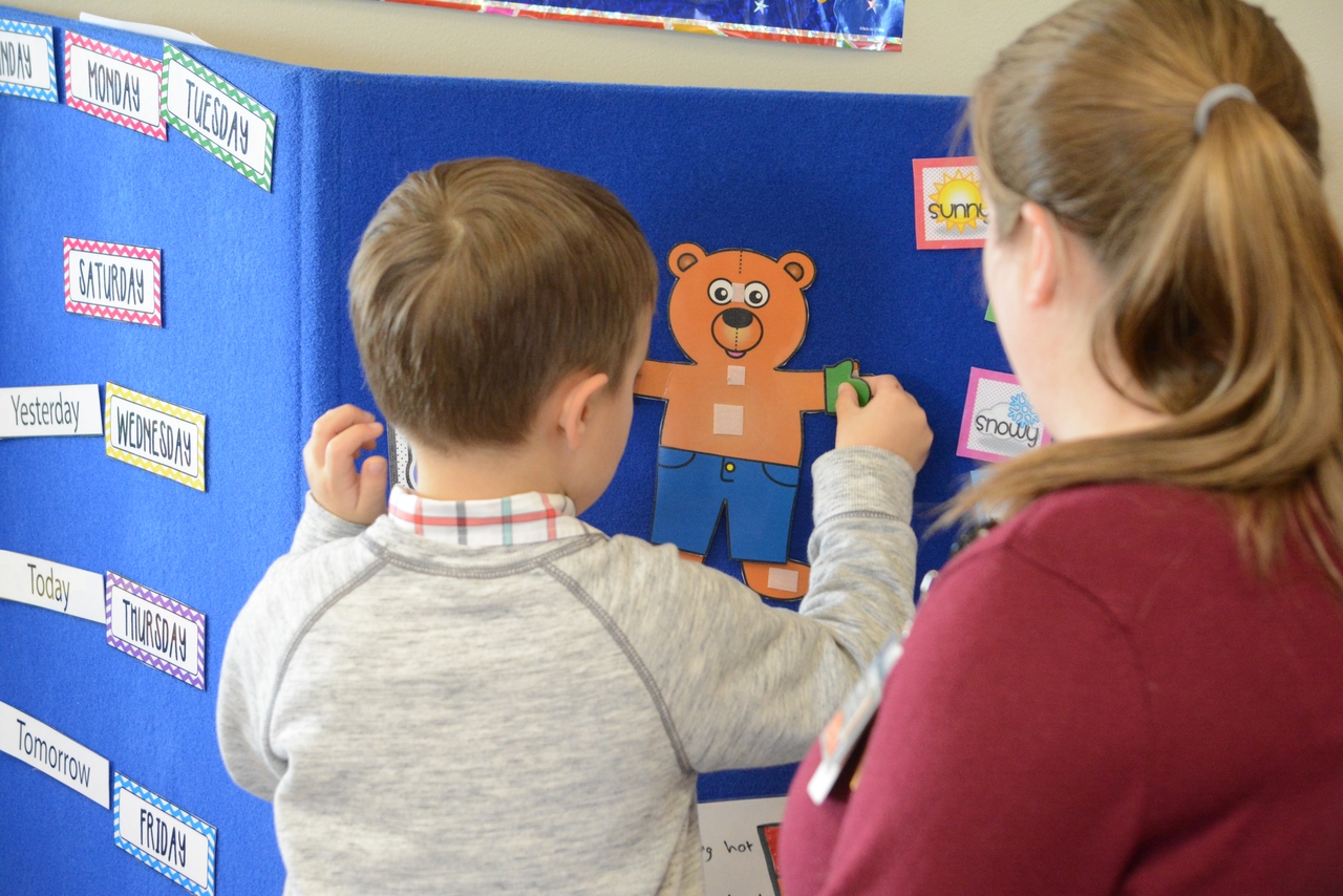 Autism Child creating a paper animal