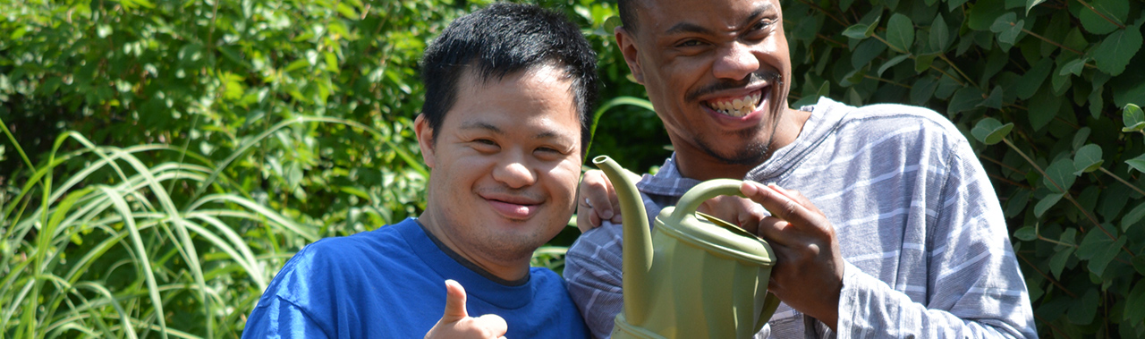 Two young men showing thumbs up