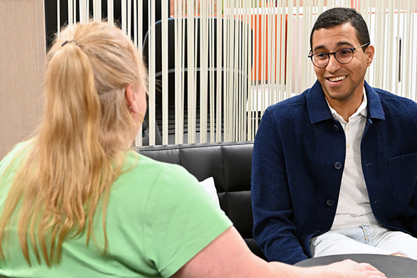 young man speaking with another person