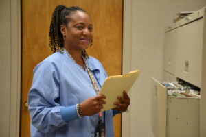 image of Deanna at filing cabinet