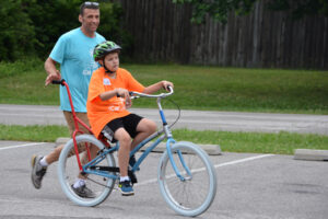 John Kelly with iCan Bike participant on bike