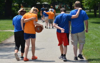 group of campers and counselors walking in park at Camp FUEL