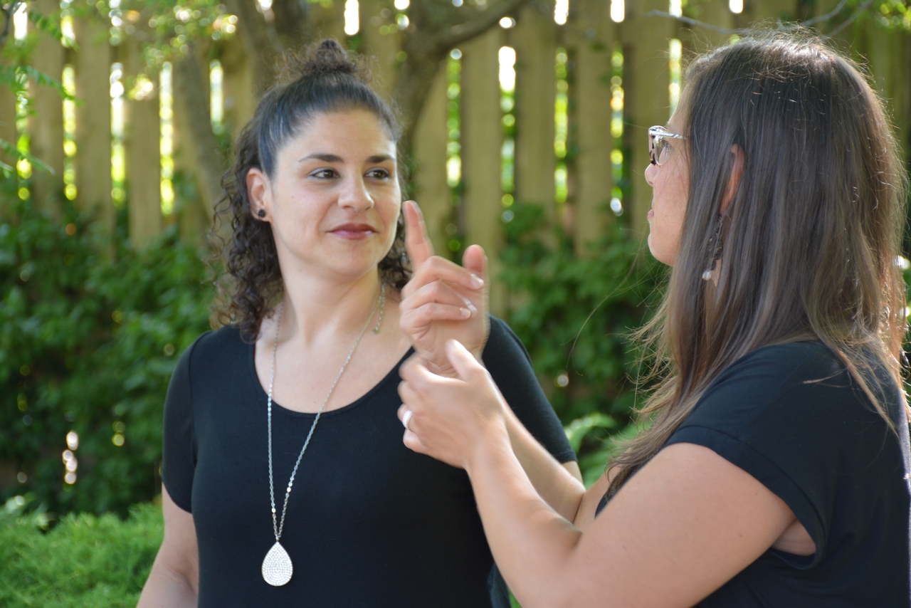 Two deaf ladies signing