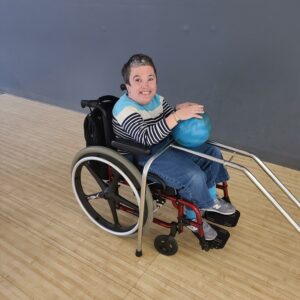 Lady using a wheelchair and bowling