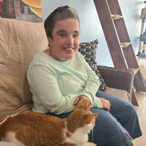 Lady sitting beside a cat