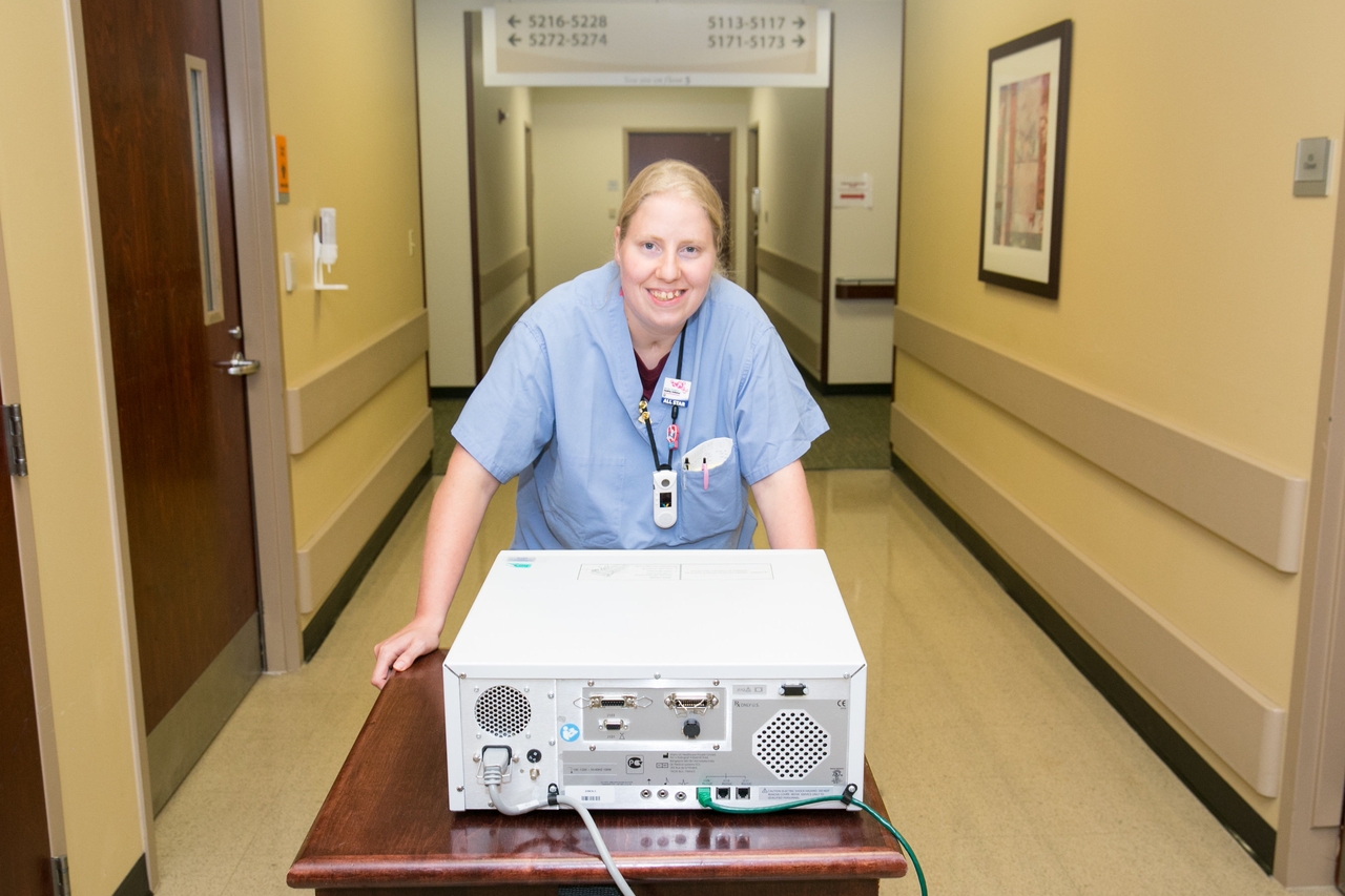 woman pushing computer cart