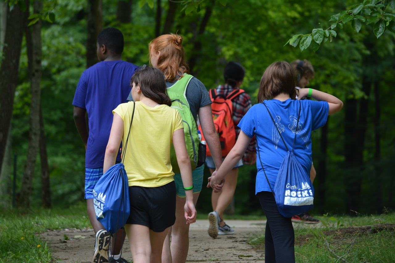 group of kids hiking in the woods