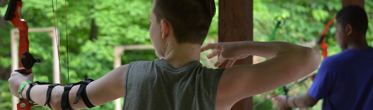 boys participating in an archery class