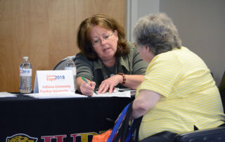 job seeker at booth at Career Expo