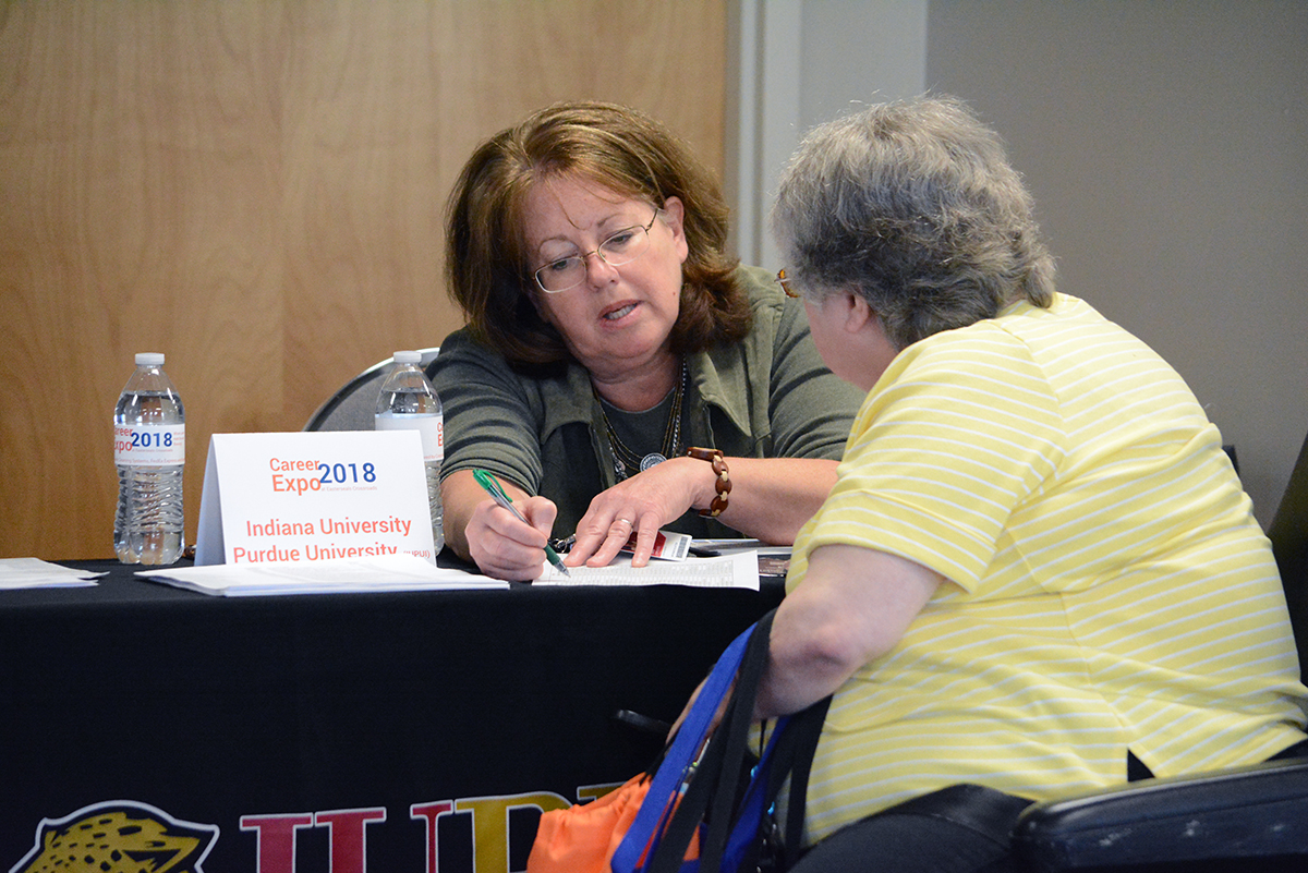 job seeker at booth at Career Expo