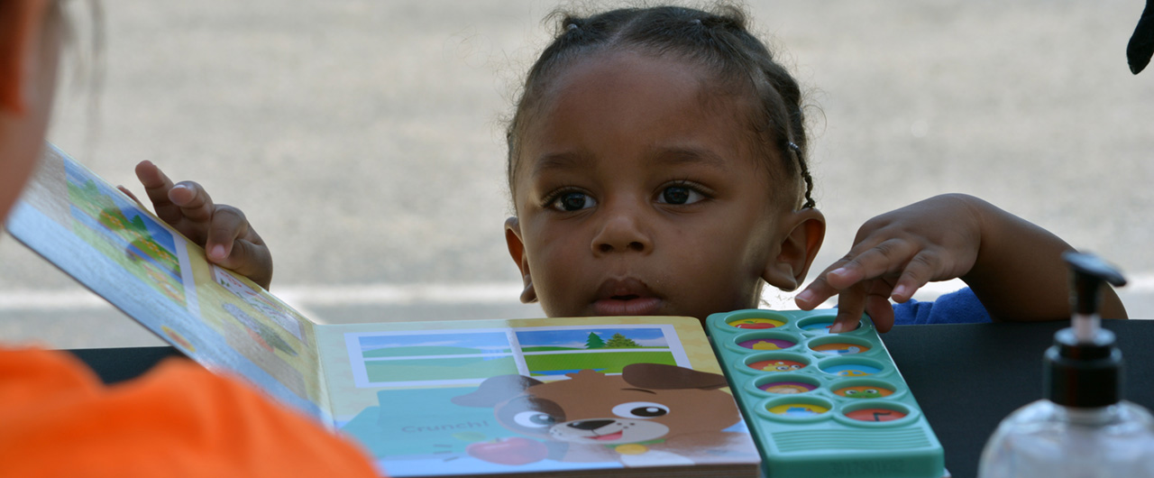 girl with book at community day