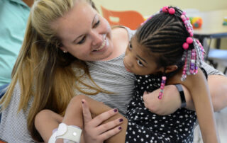 physical therapist with young girl