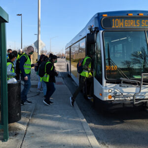 individuals stepping onto public transportation bus in Indianapolis