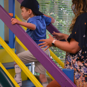 ryder stairs 4×4 young boy climbing stairs with therapist